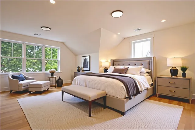 a spacious bedroom with a bed and a couch