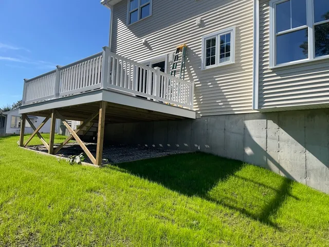 a view of a house with backyard and porch