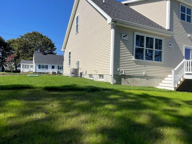 a view of house with backyard