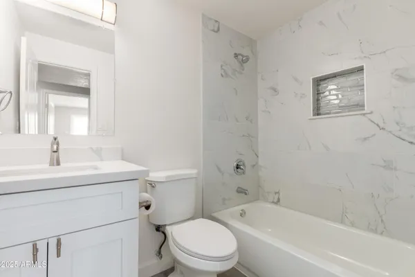a bathroom with a toilet a sink and a bathtub
