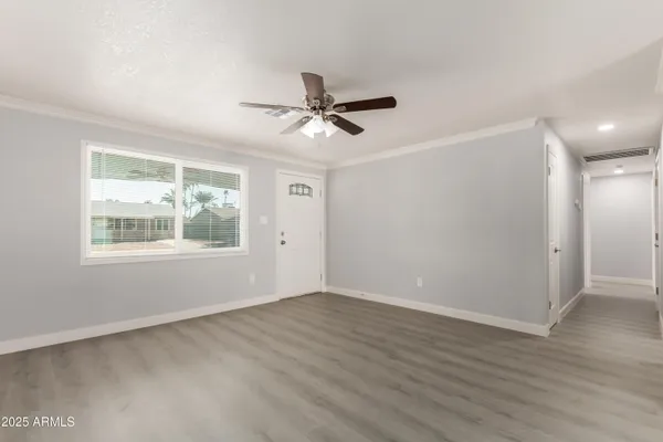 wooden floor in an empty room with a window