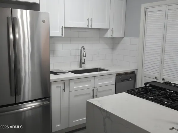 a kitchen with a sink stove and refrigerator