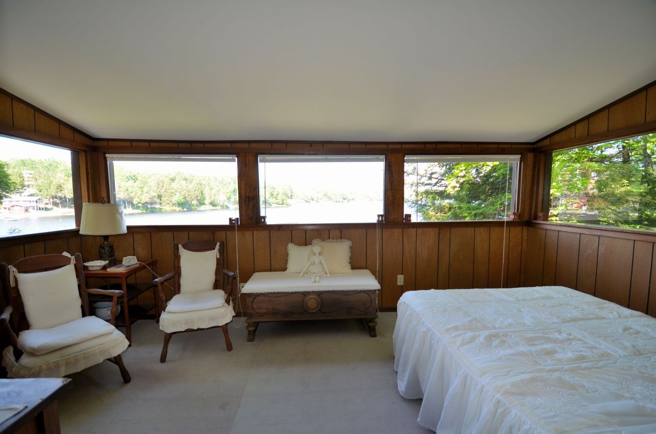 88 East Shore Road Otis, MA 01029 - Photo 14 of 16 a bedroom with a bed and large windows