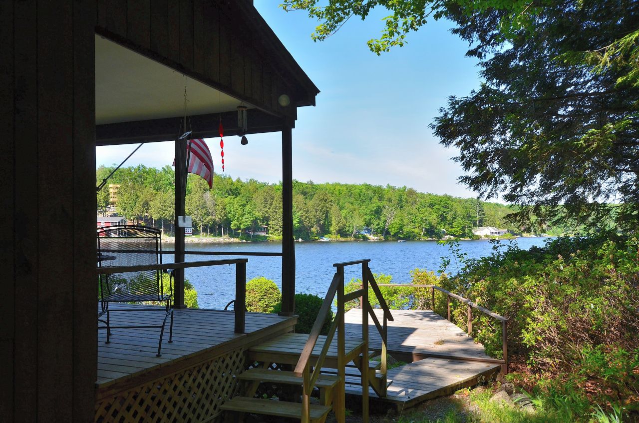 88 East Shore Road Otis, MA 01029 - Photo 3 of 16 a view of a swimming pool with a patio