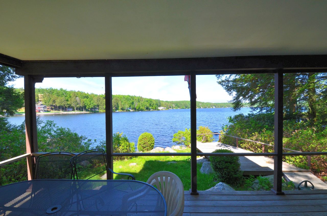 88 East Shore Road Otis, MA 01029 - Photo 8 of 16 a view of a porch with furniture and wooden floor
