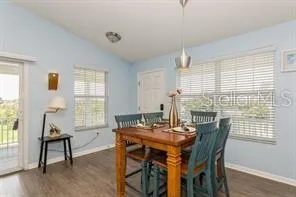a view of a dining room with furniture and windows