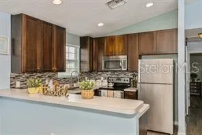 a kitchen with stainless steel appliances a refrigerator and a sink