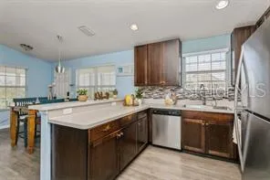 a kitchen with stainless steel appliances granite countertop a sink stove and refrigerator