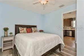 a bedroom with a bed and a view of kitchen