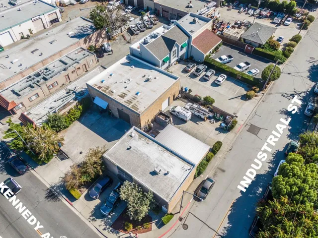 an aerial view of a residential apartment building with yard