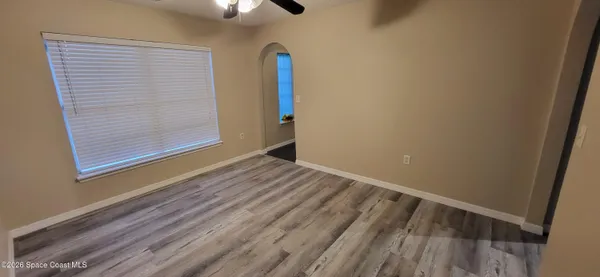 a view of empty room with wooden floor