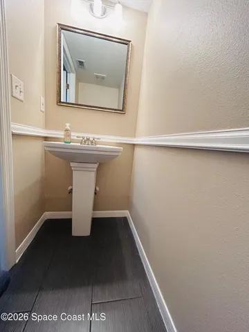 a view of a room with wooden floor and white walls