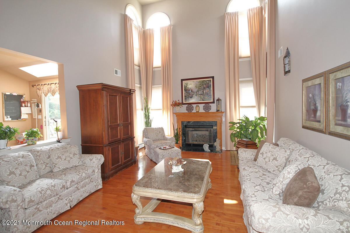 33 Maher Road Freehold, NJ 07728 - Photo 13 of 46 a living room with furniture fireplace and potted plant