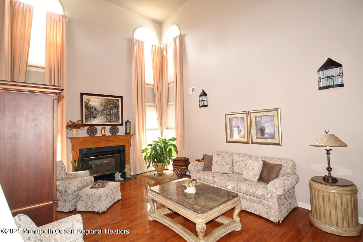 33 Maher Road Freehold, NJ 07728 - Photo 16 of 46 a living room with furniture a large window and a fireplace