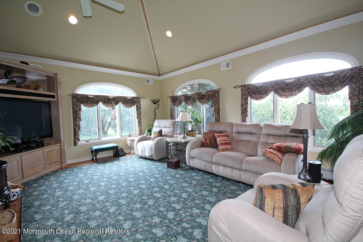 33 Maher Road Freehold, NJ 07728 - Photo 17 of 46 a living room with furniture a flat screen tv and a large window
