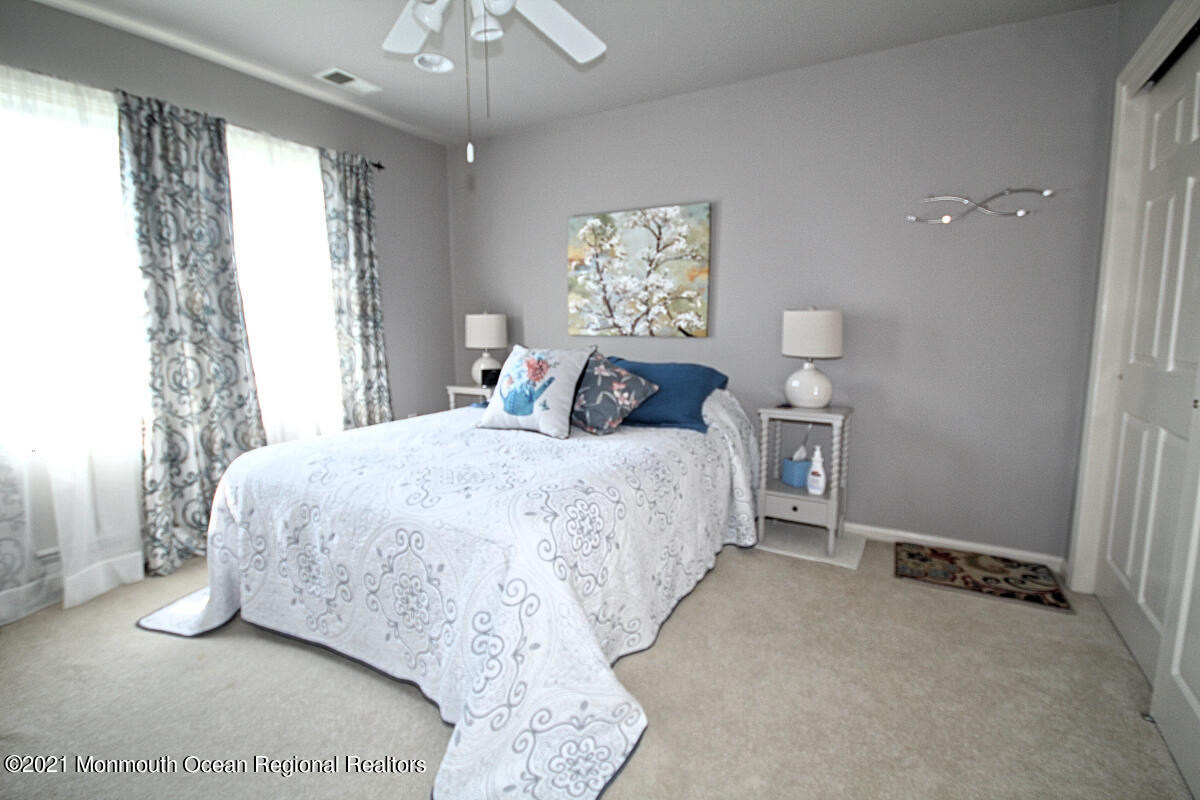 33 Maher Road Freehold, NJ 07728 - Photo 19 of 46 a bedroom with a bed and a chandelier