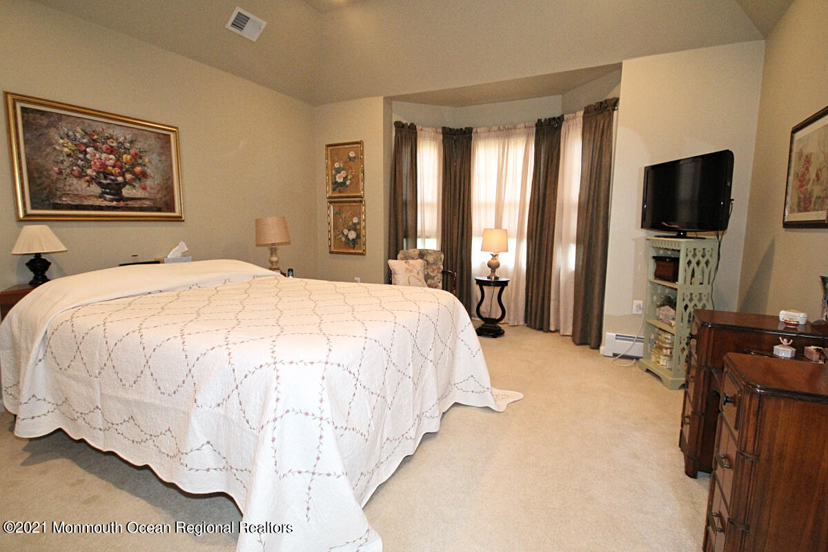 33 Maher Road Freehold, NJ 07728 - Photo 21 of 46 a spacious bedroom with a bed and a flat screen tv