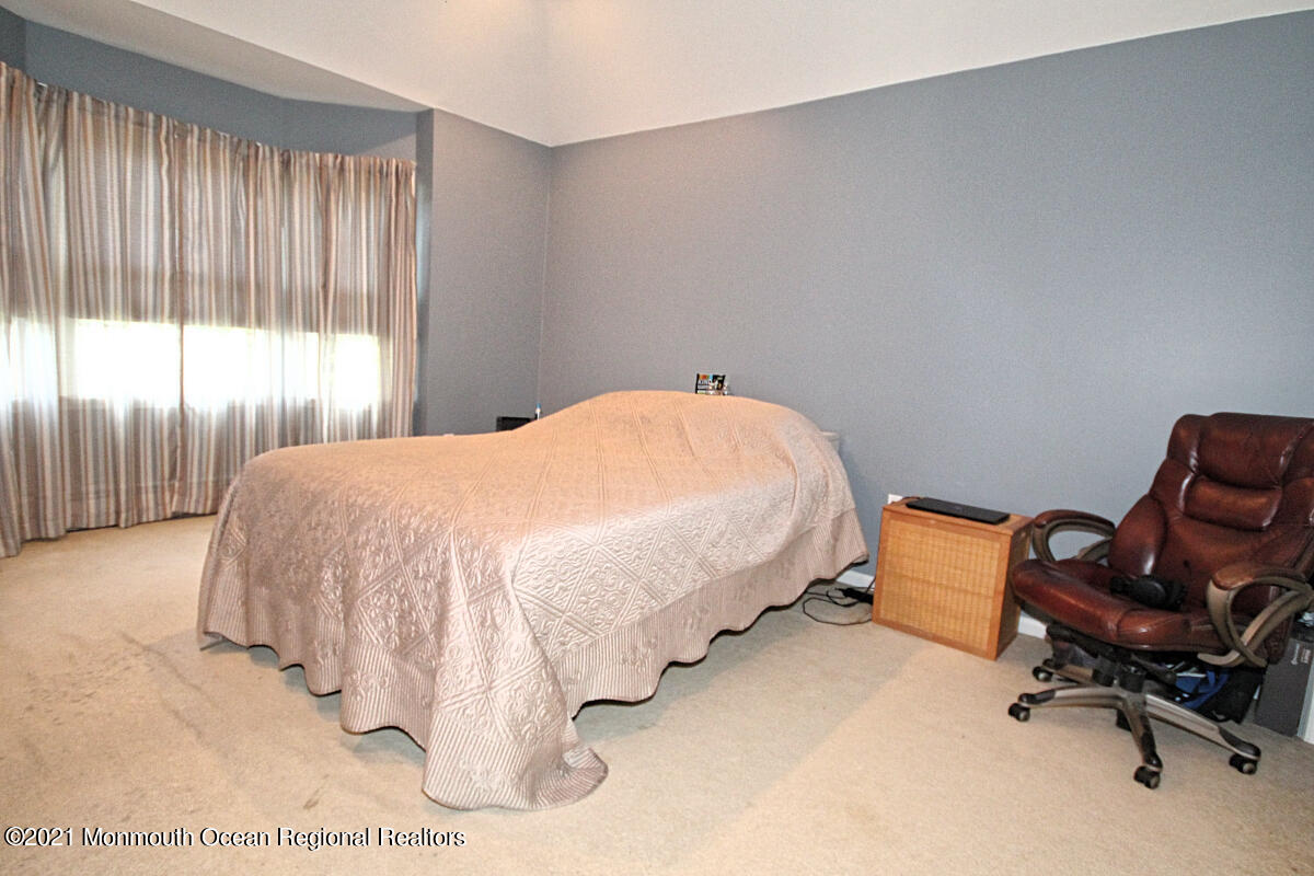 33 Maher Road Freehold, NJ 07728 - Photo 22 of 46 a bed sitting in a room next to a window