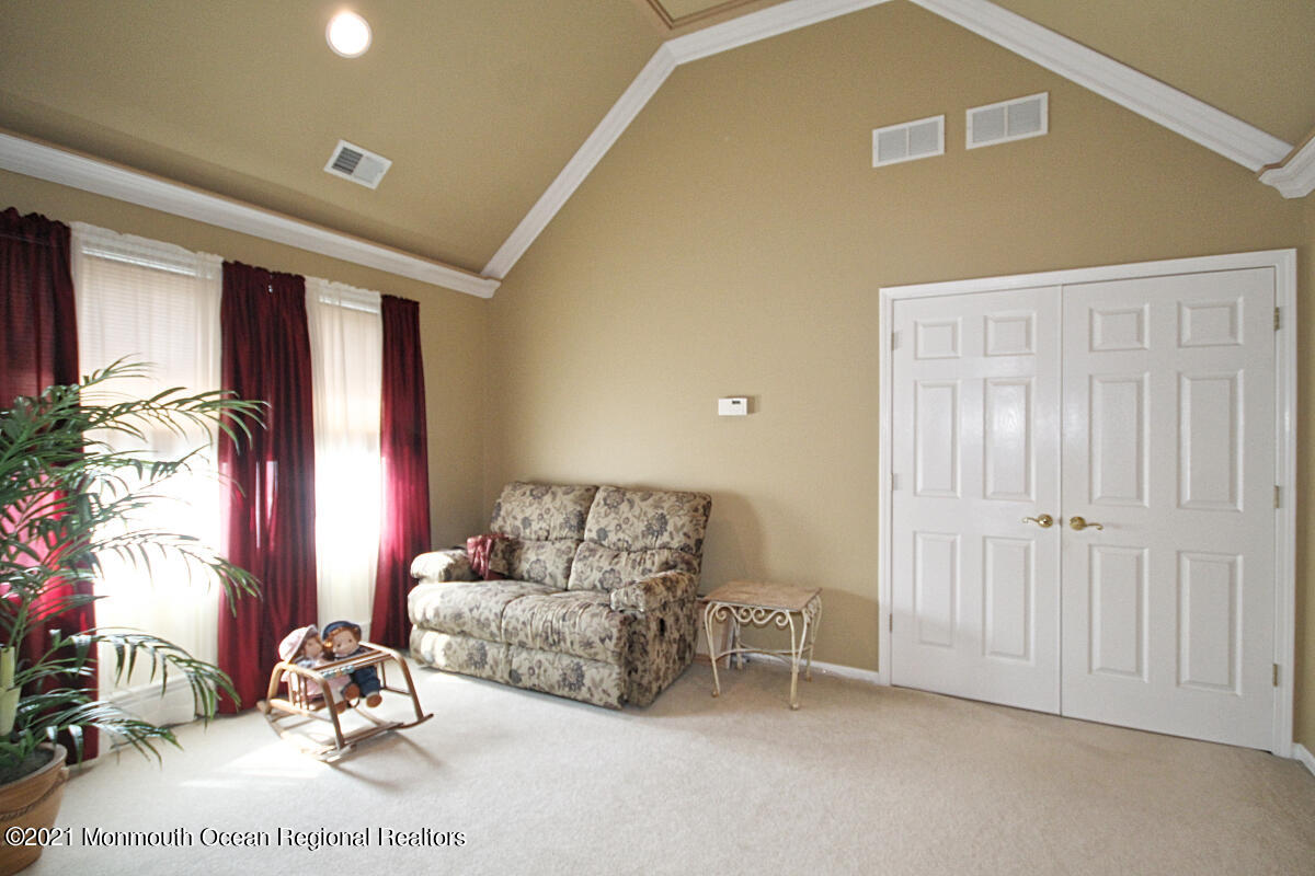 33 Maher Road Freehold, NJ 07728 - Photo 25 of 46 a living room with furniture gym equipment and a window