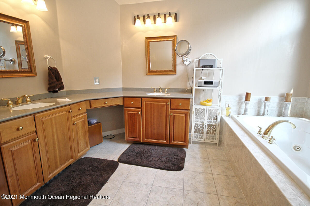 33 Maher Road Freehold, NJ 07728 - Photo 28 of 46 a large bathroom with a tub sink and mirror