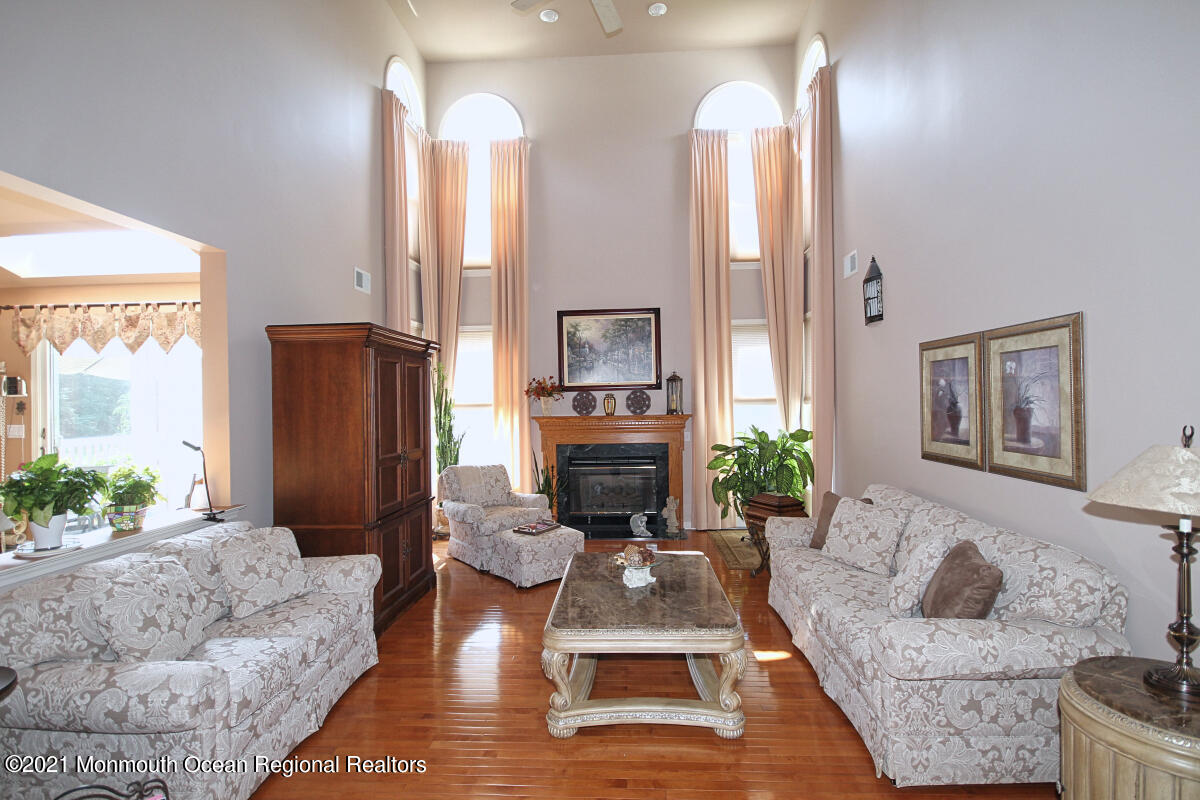 33 Maher Road Freehold, NJ 07728 - Photo 5 of 46 a living room with furniture fireplace and a large window