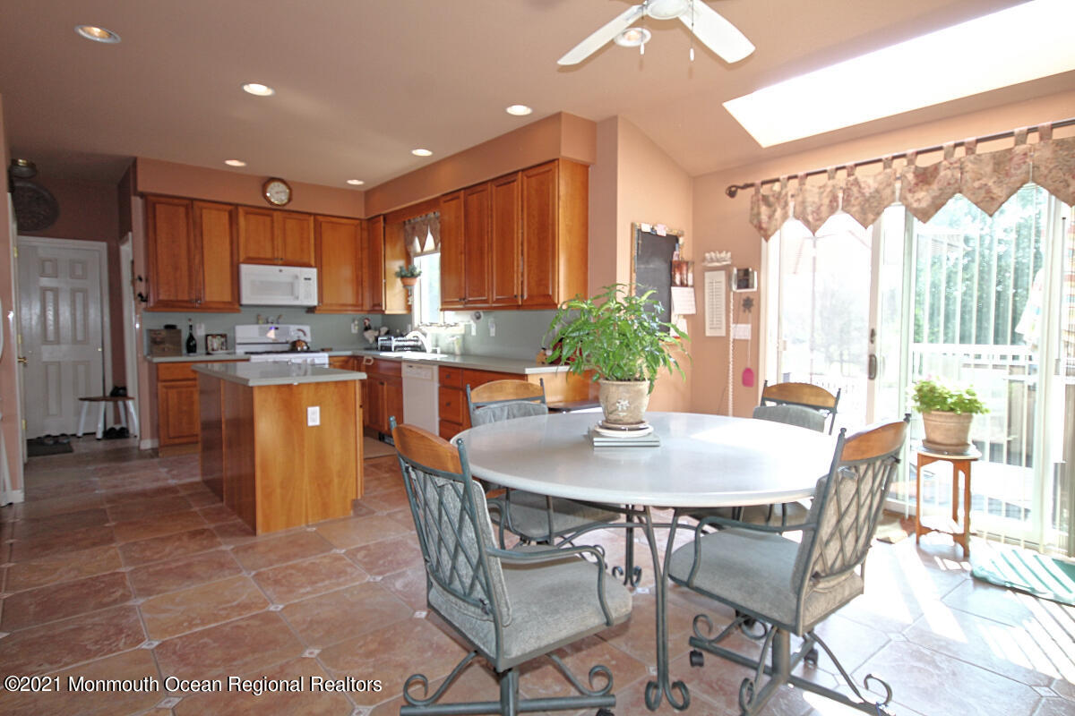 33 Maher Road Freehold, NJ 07728 - Photo 7 of 46 a kitchen with a table chairs sink and cabinets