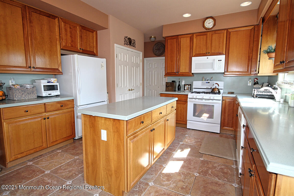 33 Maher Road Freehold, NJ 07728 - Photo 8 of 46 a kitchen with stainless steel appliances granite countertop a stove a sink a refrigerator and cabinets