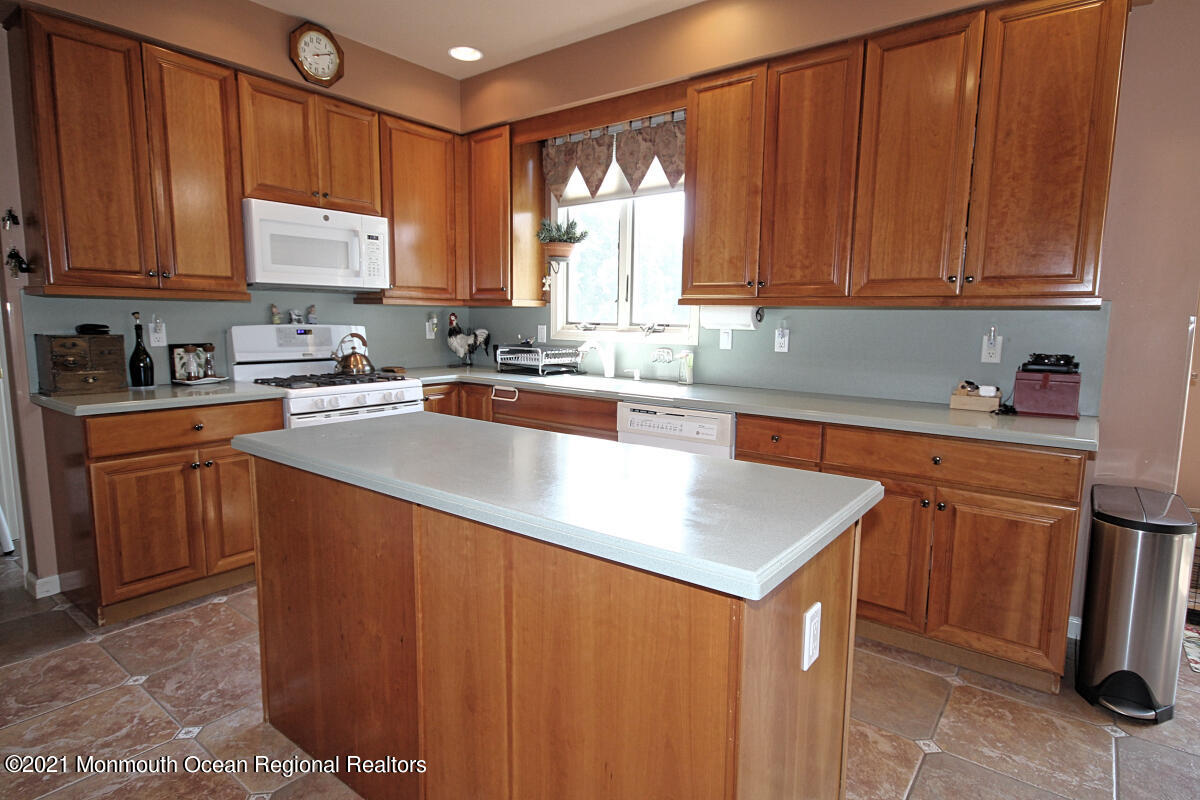 33 Maher Road Freehold, NJ 07728 - Photo 9 of 46 a kitchen with stainless steel appliances granite countertop wooden cabinets a sink and dishwasher