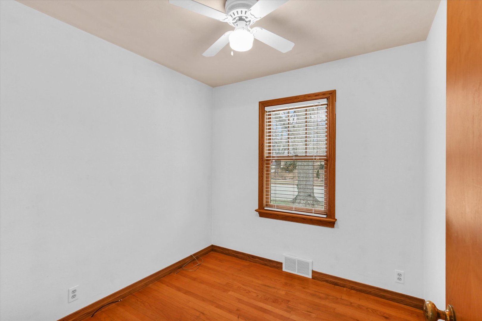 617 West John Street Champaign, IL 61820 - Photo 14 of 28 an empty room with a window and wooden floor