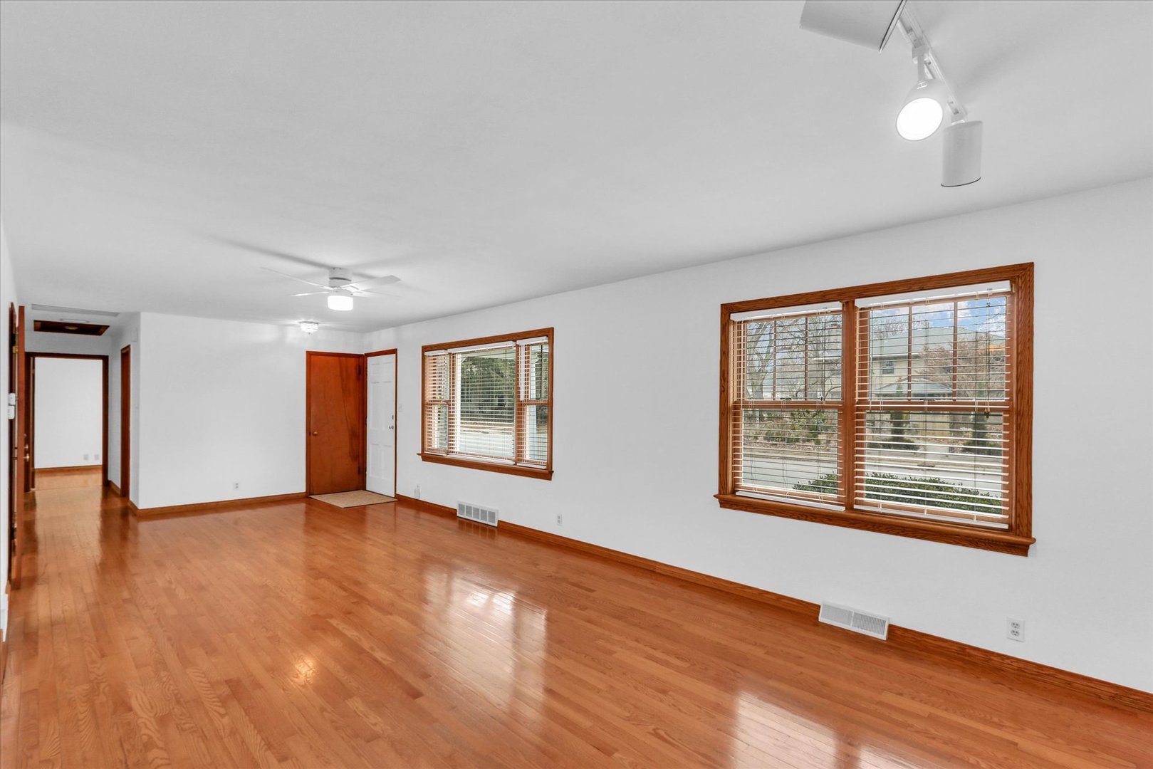 617 West John Street Champaign, IL 61820 - Photo 7 of 28 an empty room with wooden floor and windows