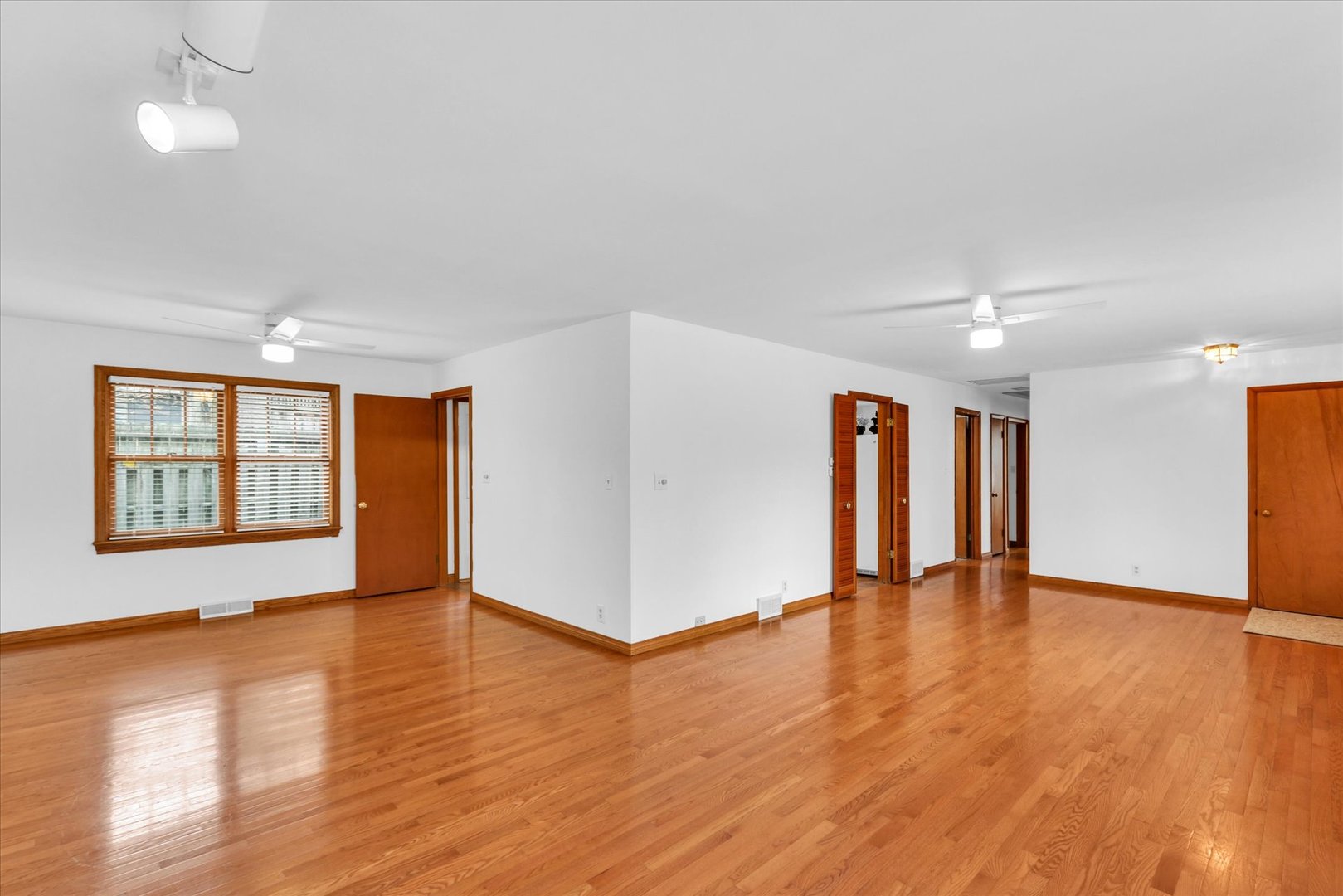 617 West John Street Champaign, IL 61820 - Photo 8 of 28 a view of an empty room with wooden floor and a window