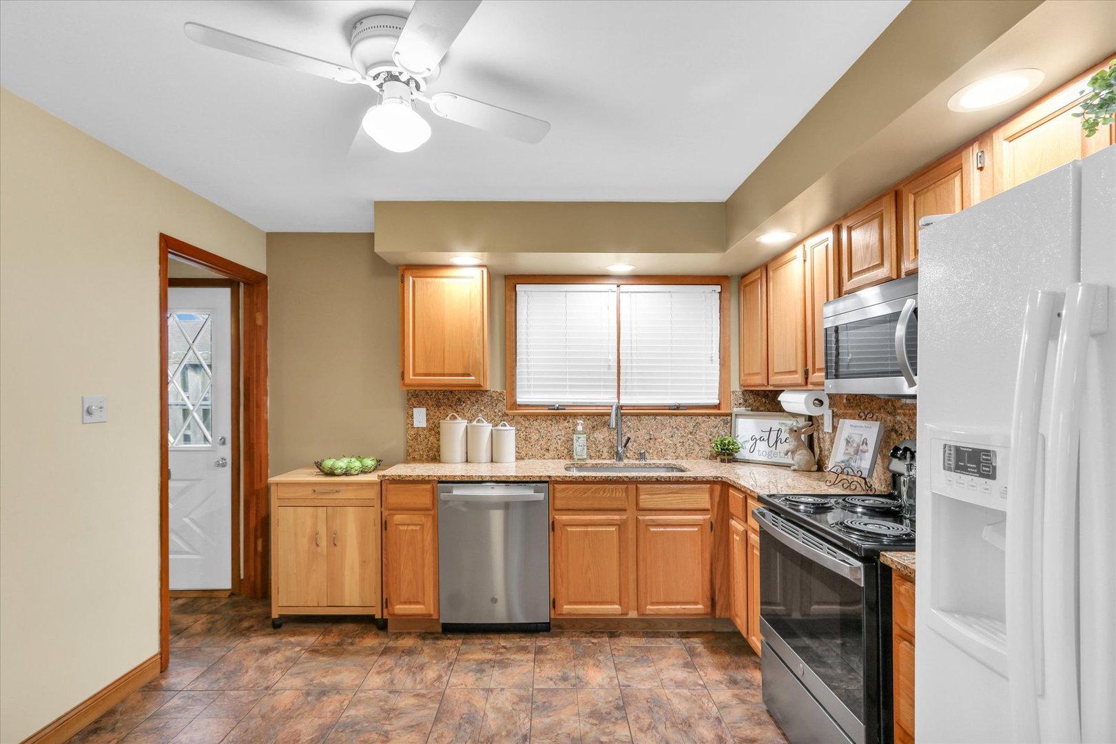 617 West John Street Champaign, IL 61820 - Photo 10 of 28 a kitchen with a sink cabinets stainless steel appliances and a window