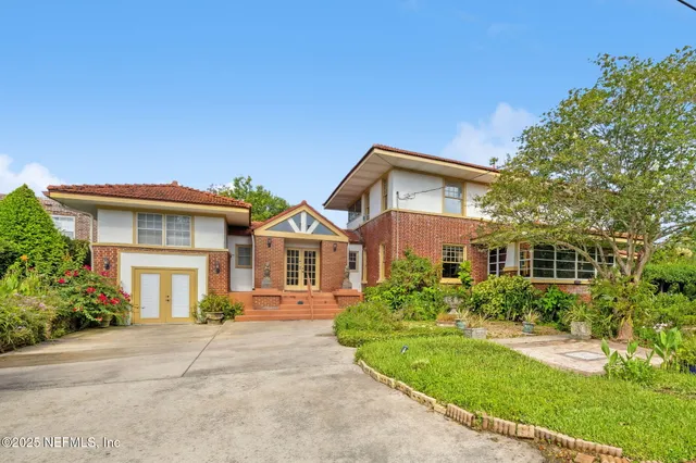front view of a house next to a yard