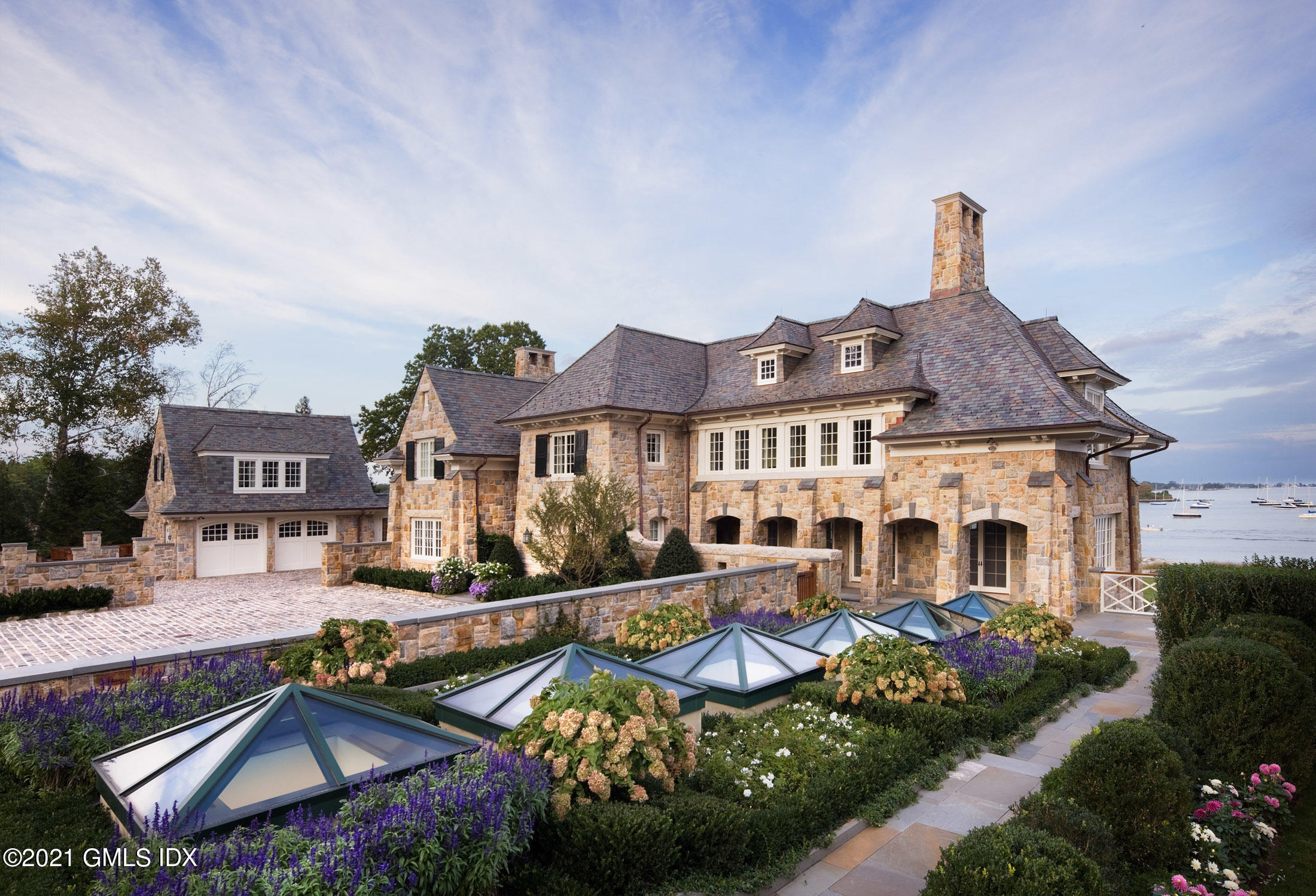 100 Field Point Circle Greenwich, CT 06830 - Photo 7 of 9 a front view of a house with garden
