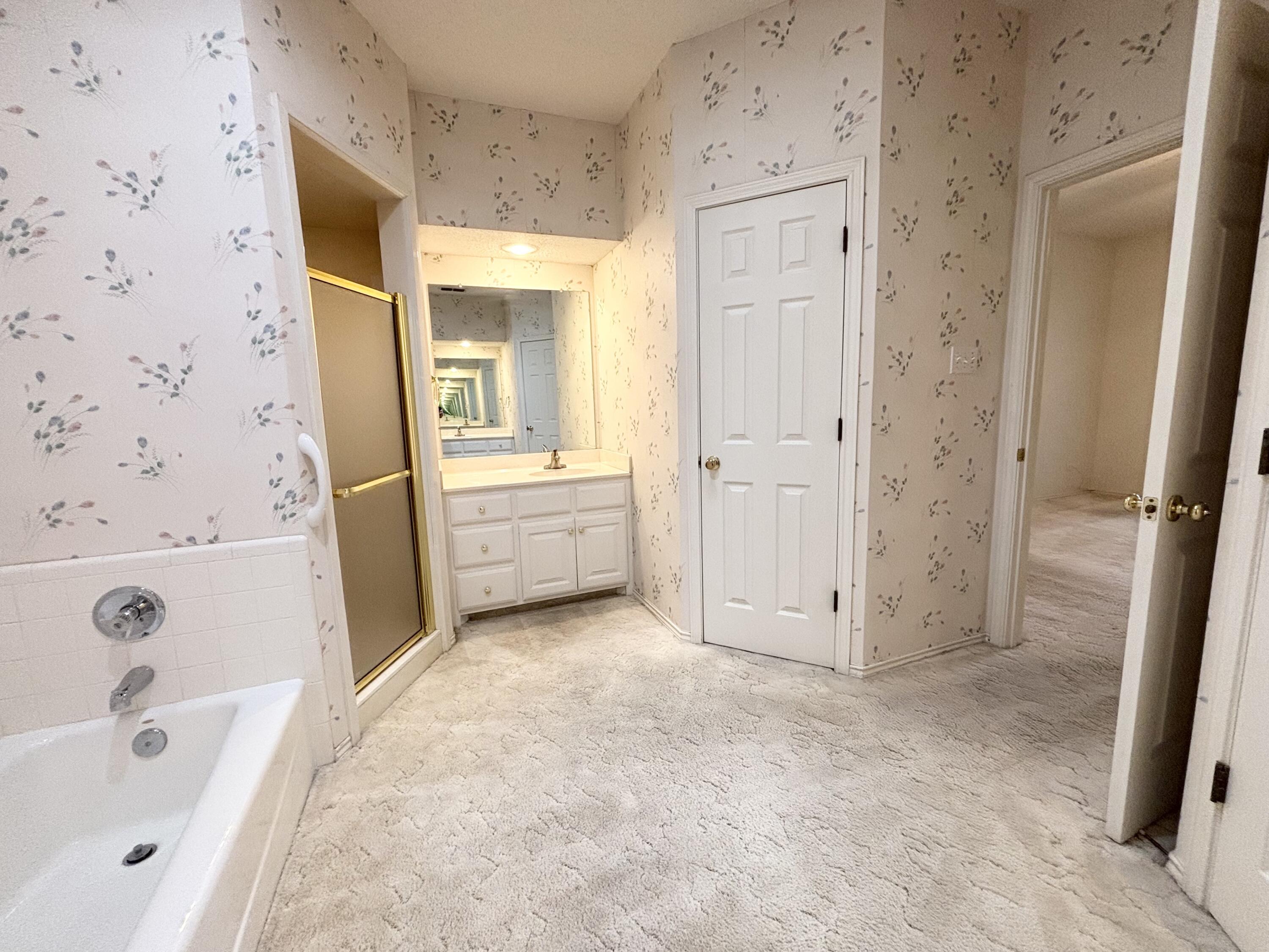 6705 Fulton Avenue Lubbock, TX 79424 - Photo 14 of 18 a bathroom with a tub sink and mirror