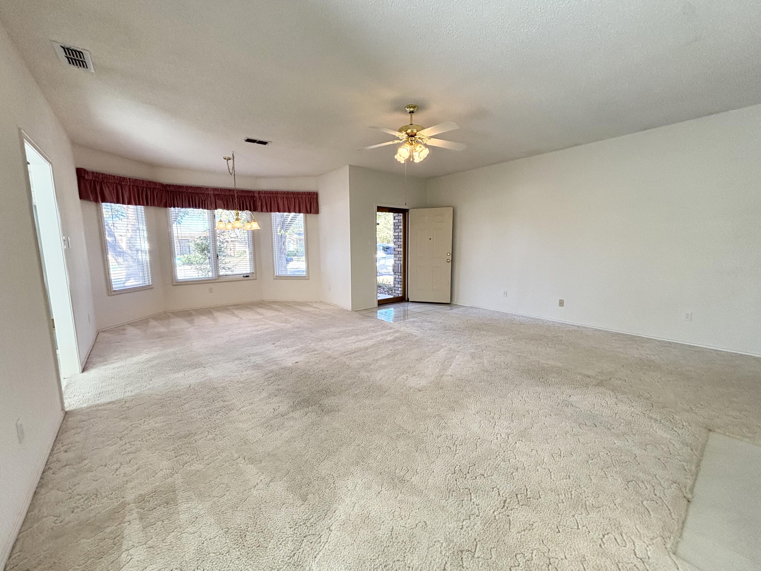6705 Fulton Avenue Lubbock, TX 79424 - Photo 4 of 18 an empty room with windows and fan