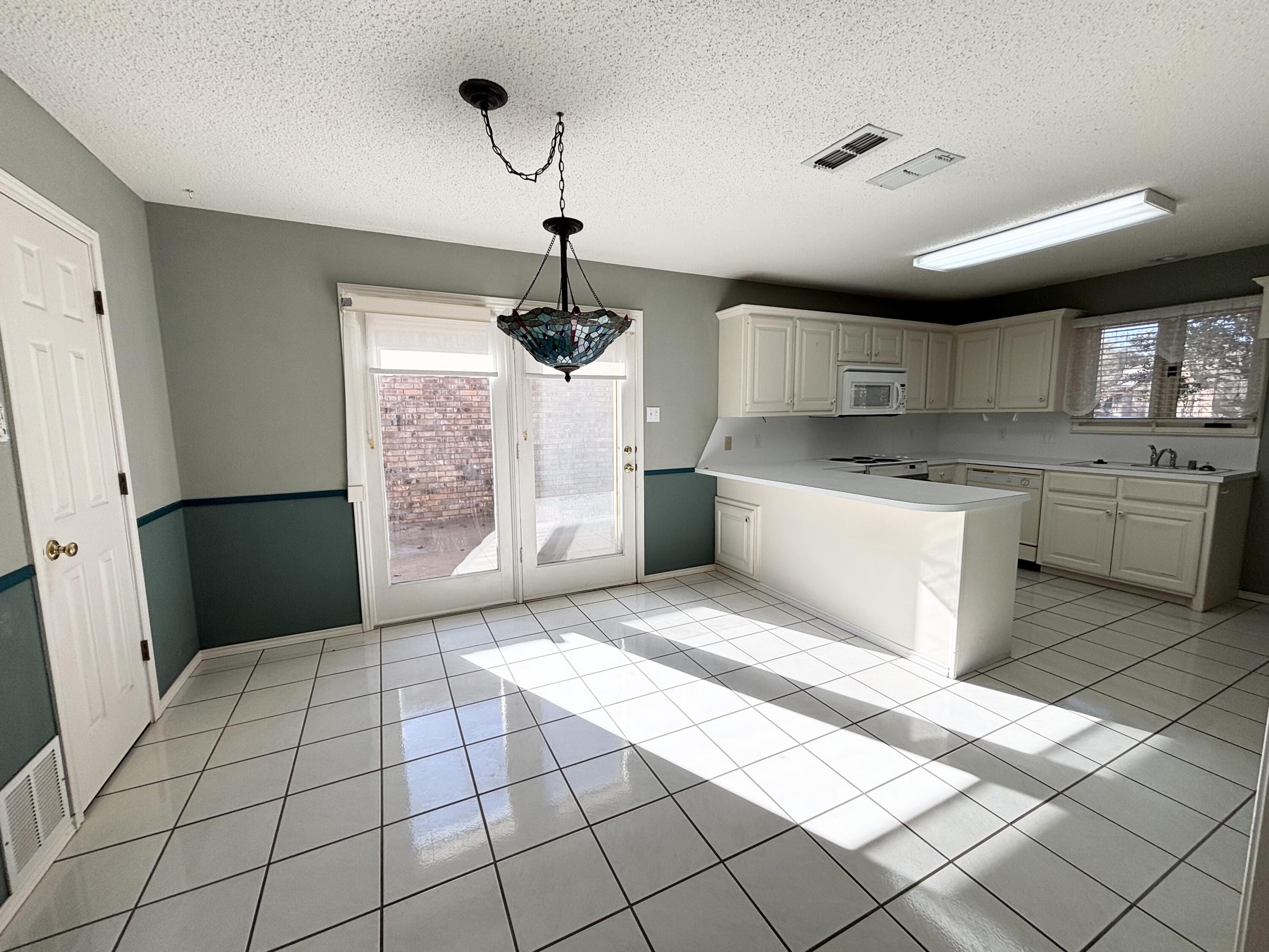 6705 Fulton Avenue Lubbock, TX 79424 - Photo 8 of 18 a large kitchen with stainless steel appliances granite countertop a stove a sink and a refrigerator