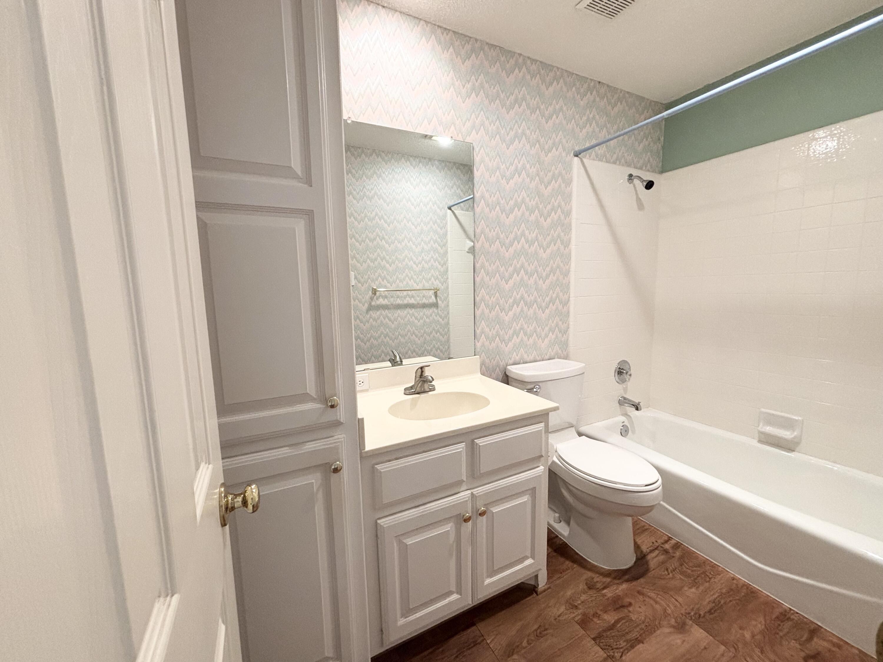6705 Fulton Avenue Lubbock, TX 79424 - Photo 9 of 18 a bathroom with a double vanity sink toilet mirror and bathtub