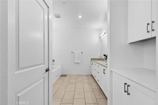 a bathroom with a double vanity sink and a shower
