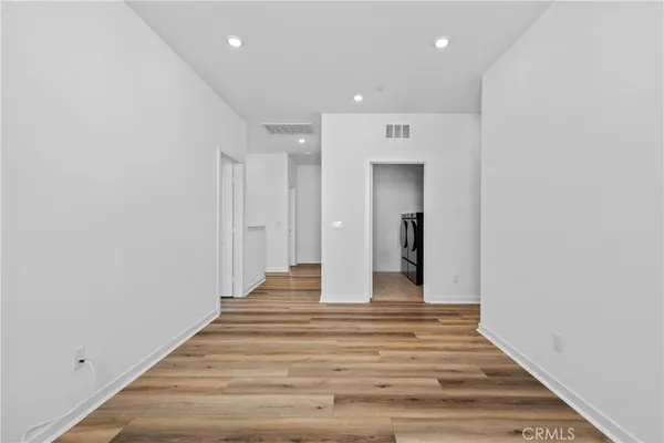 a view of a hallway with wooden floor