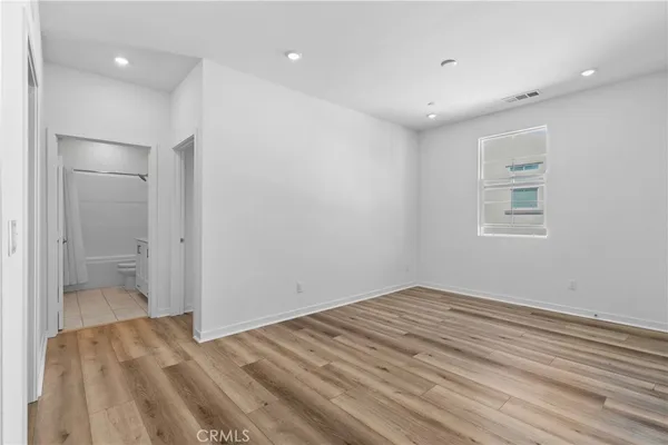 a view of wooden floor and windows in a room