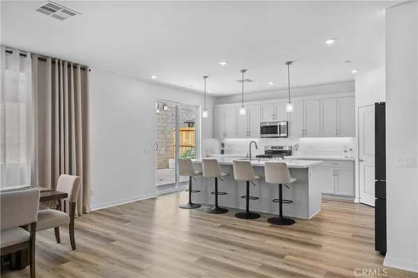 a large white kitchen with lots of counter space and furniture