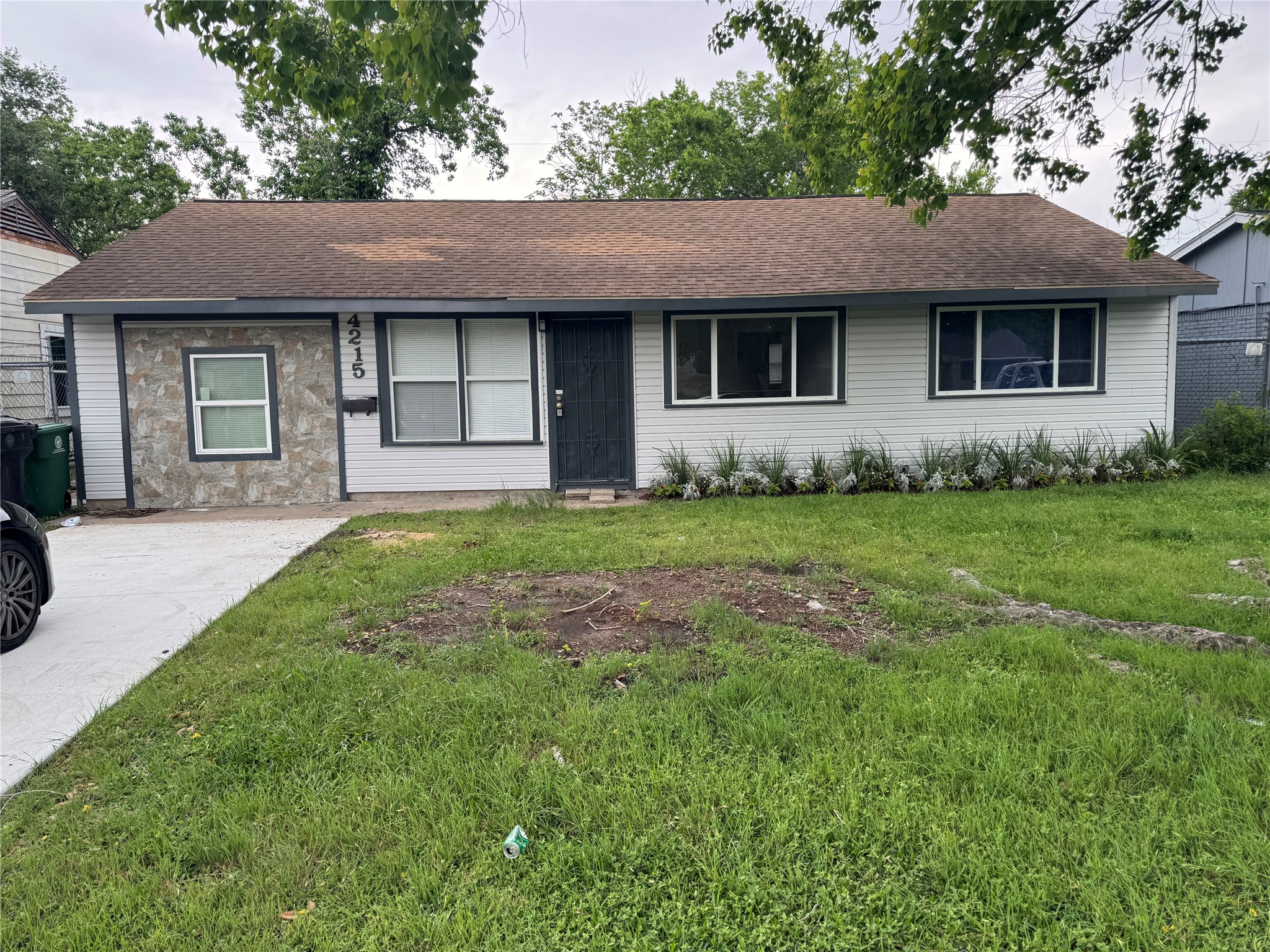 a front view of a house with a garden