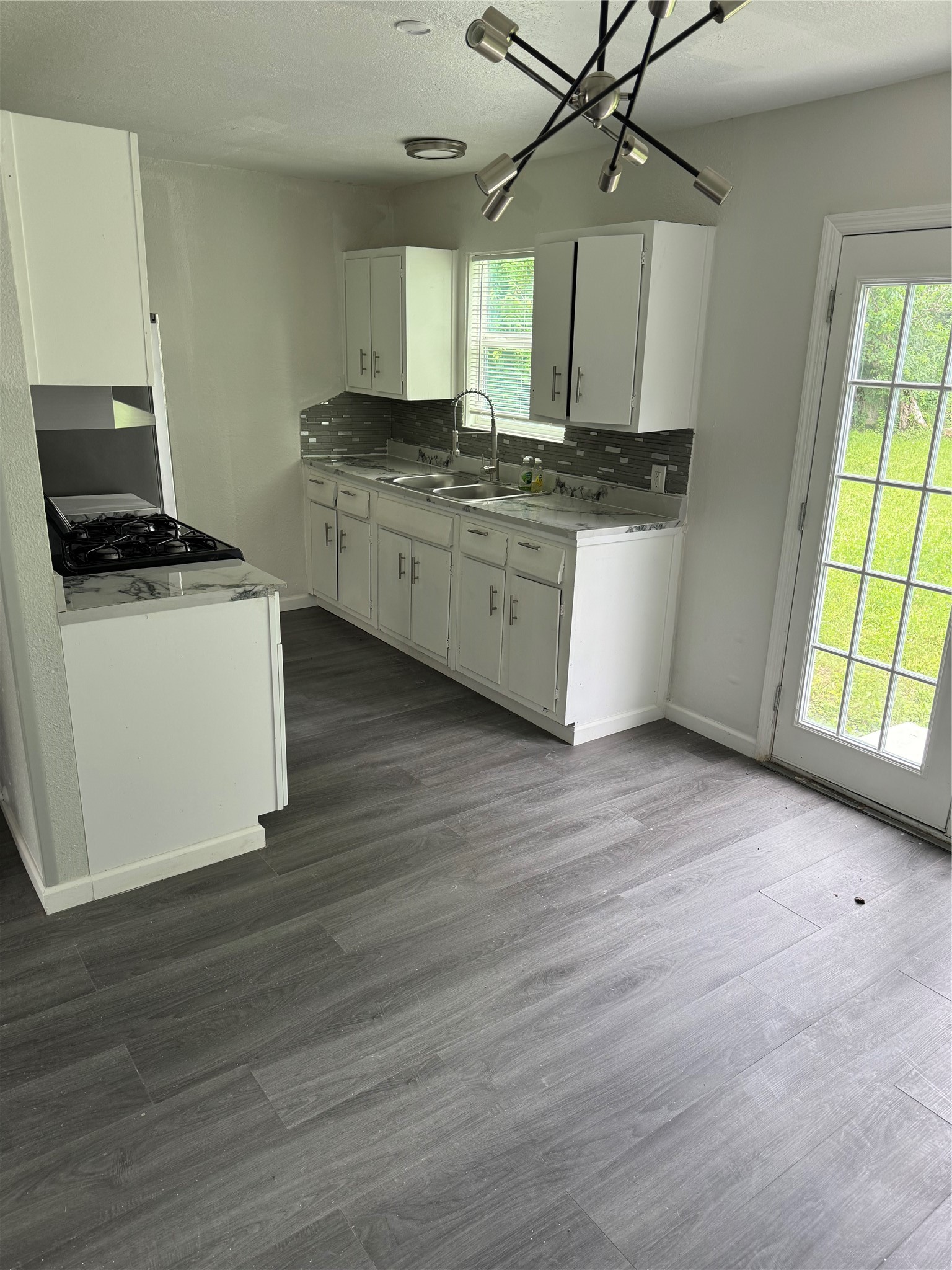 4215 Botany Lane Houston, TX 77047 - Photo 11 of 23 a kitchen with stainless steel appliances granite countertop a stove a sink and a microwave