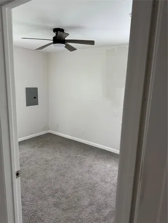 an empty room with windows and closet