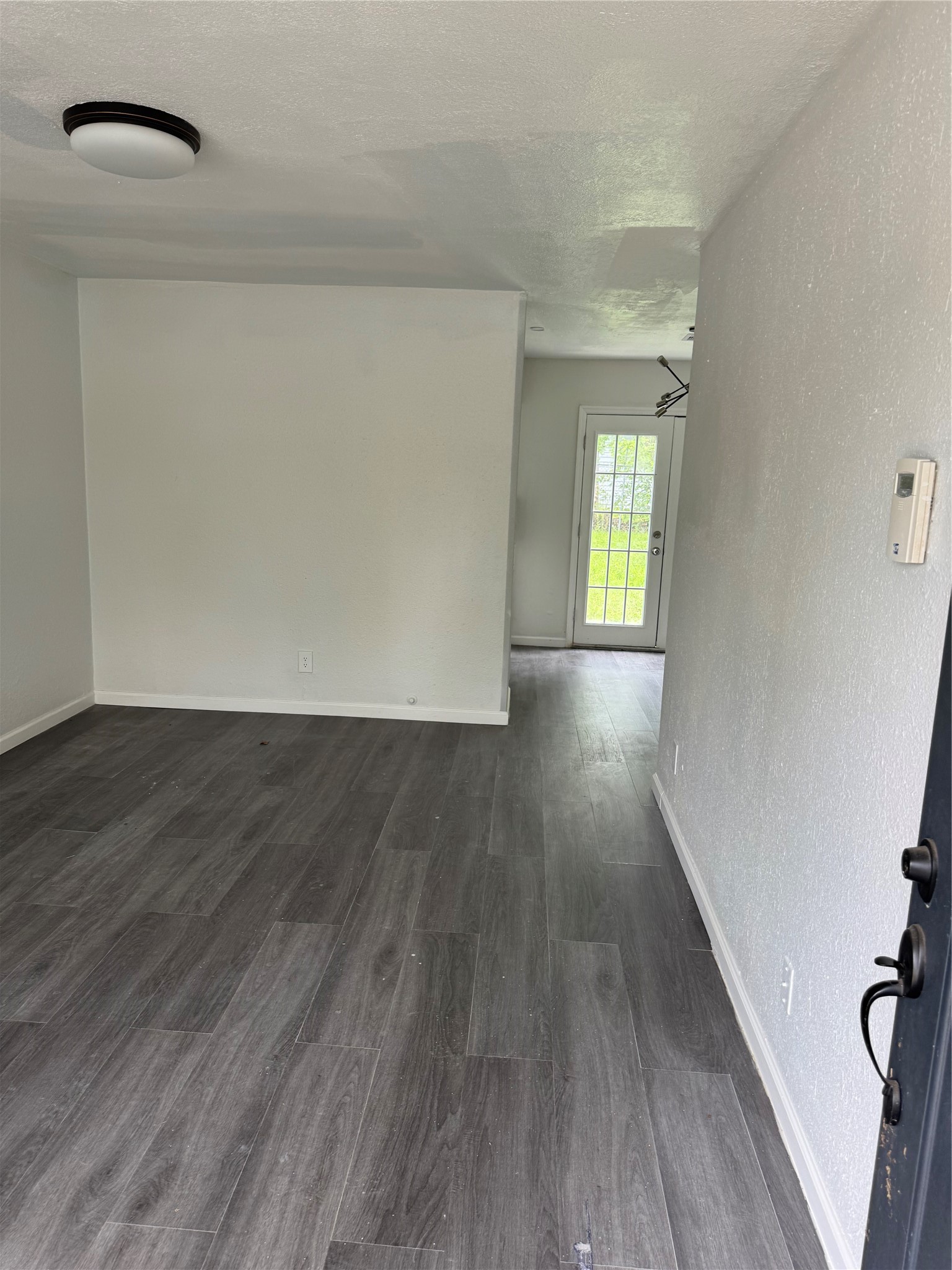 4215 Botany Lane Houston, TX 77047 - Photo 3 of 23 an empty room with wooden floor and windows