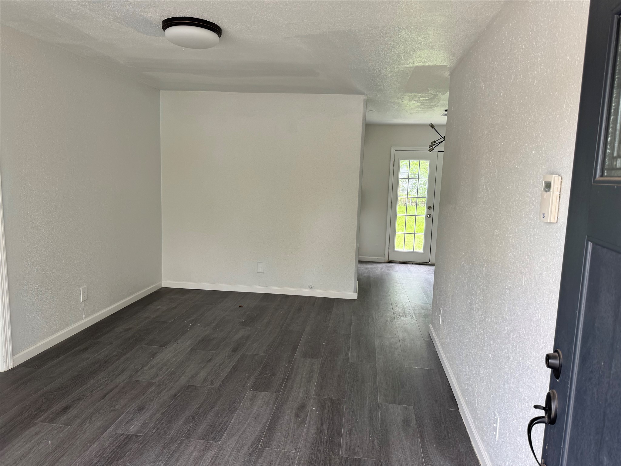 4215 Botany Lane Houston, TX 77047 - Photo 4 of 23 an empty room with wooden floor and windows