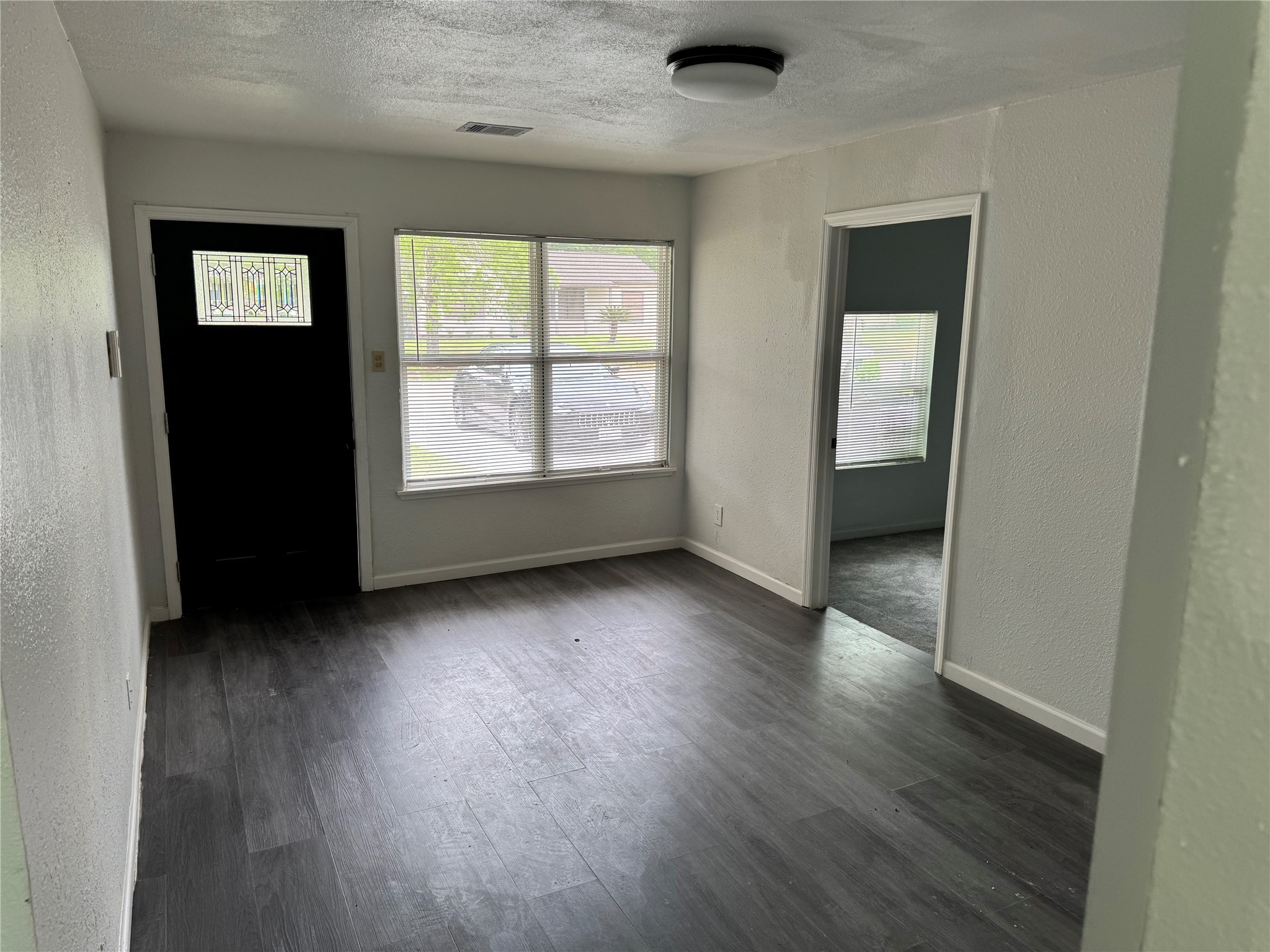 4215 Botany Lane Houston, TX 77047 - Photo 5 of 23 an empty room with wooden floor and windows