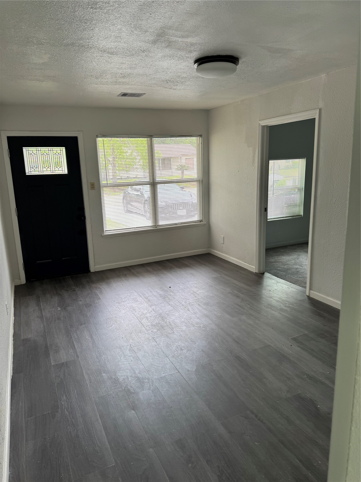 4215 Botany Lane Houston, TX 77047 - Photo 6 of 23 an empty room with wooden floor and windows