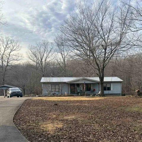 a front view of house with yard and trees